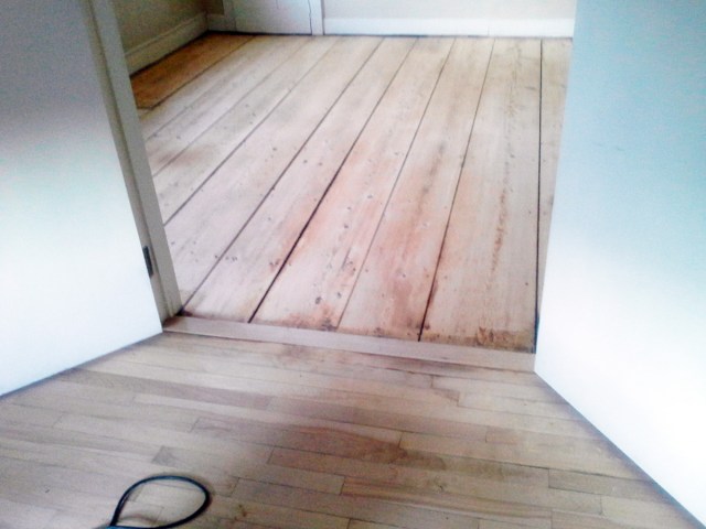 Here are both rooms sanded. The small room has oak and maple and the big room has big pine boards that span the entire length of the room