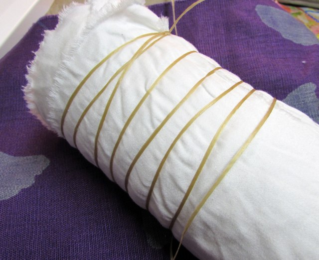 I wrapped the fabric around the pole probably twice. It was till damp so it sort of stuck to itself. Then I started the wrapping with the sinew.