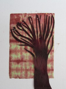 so I started here. Cut into a strip of wool and fanned out the strips for the branches and placed it on one of my hand dyes